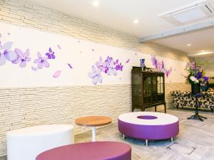 a room with purple and purple stools and a wall with butterflies at Kyoto Four Sisters Residence in Kyoto