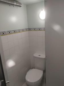 a white bathroom with a toilet and a tub at Quinta dos Campos - Apartamento 1 in Braga