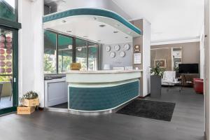 a kitchen with a counter in the middle of a room at Hotel Poli in Castelnovo di Sotto