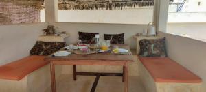 a table and two chairs in a room with a table at Furaha House in Shela