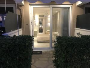 a view of a bedroom through a glass door at Porto Palio Beach Hotel in Paleo Tsifliki