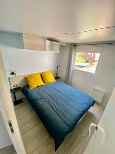 a small bed in a small room with a window at Mobilhome 6 places vue mer in Drammont