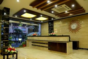 a lobby with a reception desk in a building at Hotel U.T.Elegance in Bangalore