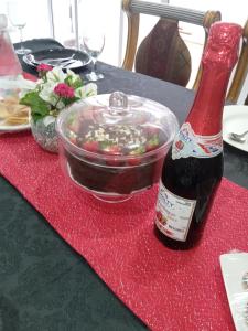 a bottle of beer on a table with a bowl of food at EYEZULU Guesthouse in Pinetown