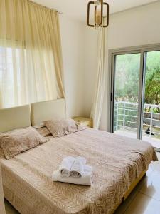 ein Schlafzimmer mit einem Bett mit Handtüchern darauf in der Unterkunft Beautiful & Quiet Two-Bedroom Apartment with Private Garden Lukomorye C1 in Kyrenia