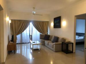 a living room with a couch and a bed at Beach Resort Home Stay Batu Ferringhi 02 in Batu Ferringhi