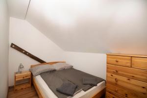 A bed or beds in a room at Szobi Malomkert Lovarda
