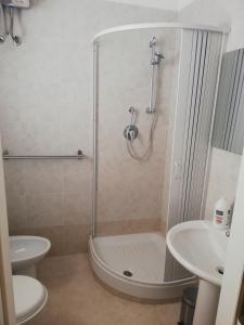 a bathroom with a shower and a toilet and a sink at Lido Venere Case Vacanze in Metaponto