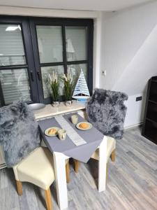 a dining room with a table and two chairs at Exklusive Ferienwohnung nahe der Nordsee in Wesselburen