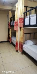 three bunk beds in a dorm room with at บ้านโอเค โฮสเทล OK HOME hostel in Ban Khlong Thewa