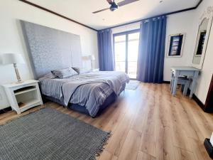 a bedroom with a bed and a large window at 15 Sovereign Sands in KwaDukuza