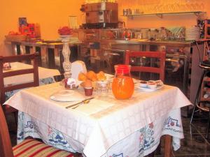 a table with a plate of fruit on it in a kitchen at Agriturismo La Prosciutta in Faenza