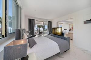 1 dormitorio con 1 cama grande y TV en Appartements Croisette Grand Hôtel en Cannes