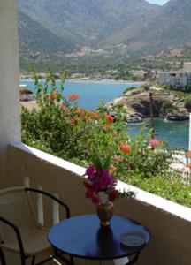 stół z wazą kwiatów na balkonie w obiekcie Dimitris Apartments w mieście Balíon