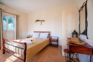 een slaapkamer met een bed, een tafel en een piano bij Agios Sostis Village Apartments in Laganas