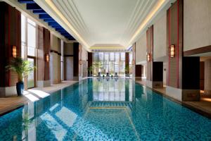 a large swimming pool in a building with a lobby at Shangri-La Resort Shangri-La in Shangri-La