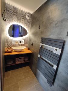 a bathroom with a sink and a mirror at Domaine Nature Cottage Vosges Spa in Anould +42 photos