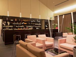 a waiting room with chairs and a bar at Casalgrande Hotel in Salvaterra