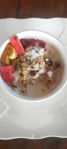 a bowl of soup with fruit and nuts on a table at Sweet Time Bungalows in Koh Rong Sanloem
