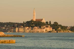 a large building on an island in a body of water at Maistra Camping Amarin Glamping in Rovinj