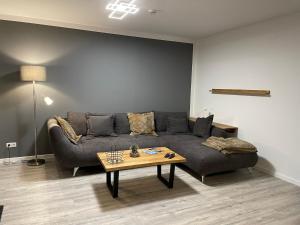 a living room with a couch and a coffee table at Ferienhaus Diemelblick in Heringhausen