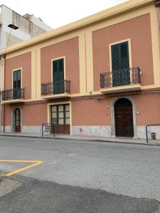a building with two balconies on a street at Casa Cristina in Alì Terme