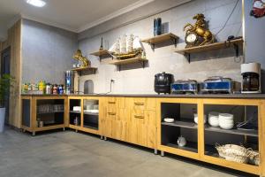 a large kitchen with wooden cabinets and shelves at THE TIME HOTEL in Tashkent