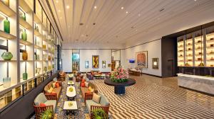 a lobby of a hotel with tables and chairs at Welcomhotel By ITC Hotels, Guntur in Guntūr
