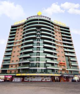 un gran edificio con un cartel encima en Emirates Stars Hotel Apartments Dubai, en Dubái