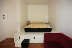 ナポリにあるCebollitas B&Bの白いキャビネットの上にベッド1台が備わるベッドルーム1室が備わります。