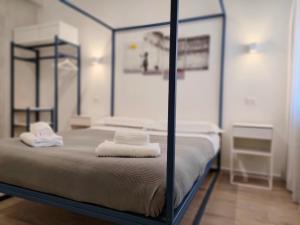 A bed or beds in a room at Central Rooms Matera