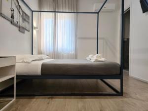 A bed or beds in a room at Central Rooms Matera