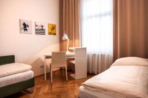 a hotel room with a bed and a desk and a table at Riess Apartments Rotenhofgasse | contactless check-in in Vienna
