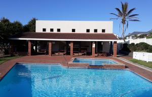 a large swimming pool in front of a building at Laguna la Crete 99, Uvongo in Margate