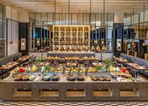 a buffet of food on a table in a restaurant at Welcomhotel By ITC Hotels, Guntur in Guntūr