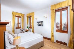 una camera con un letto e due finestre di All’Angelo Art Hotel a Venezia