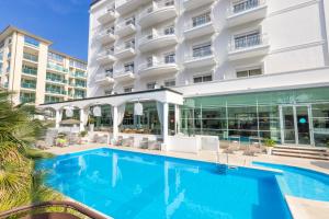 a swimming pool in front of a hotel at Hotel Continental in Rimini