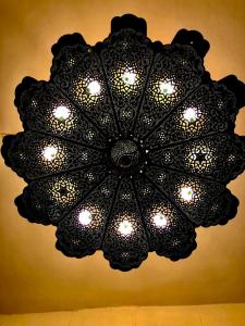 a black chandelier hanging from a ceiling at Gamaleya Boutique Hotel in Cairo