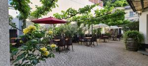 an outdoor patio with tables and chairs and umbrellas at Weingut Haxel in Cochem
