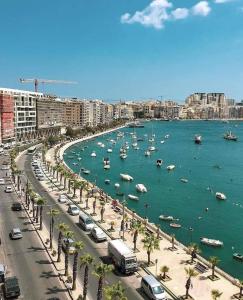 a city with boats in the water and a harbor at Large apartment close to rocky beach MCRE1-1 in Sliema