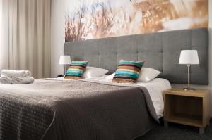
Łóżko lub łóżka w pokoju w obiekcie Baltic Hotel
