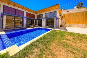 a house with a swimming pool in the backyard at Flower Hotel Patara in Patara