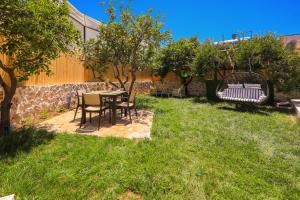 a patio with a table and chairs in a yard at Flower Hotel Patara in Patara