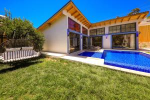 a house with a swimming pool in the yard at Flower Hotel Patara in Patara