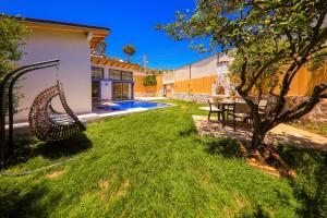 a yard with a swing next to a house at Flower Hotel Patara in Patara
