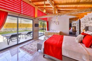 a bedroom with a large bed and a dining room at Flower Hotel Patara in Patara
