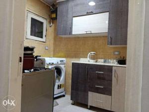 a kitchen with a washing machine and a washer at Nasr city Studio 2bedrooms 4beds in Cairo