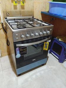 a stove in a kitchen with a sign on it at Down Town apartment Nasr city in Cairo