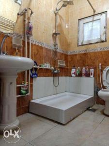 a bathroom with a tub next to a sink and a toilet at Down Town apartment Nasr city in Cairo