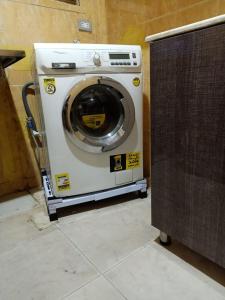 a washing machine sitting in the corner of a room at Down Town apartment Nasr city in Cairo